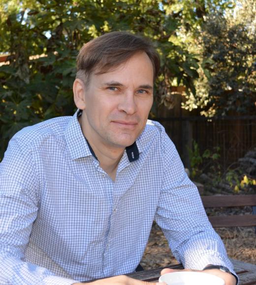 A picture of Professor Rose looking at the viewer, wearing a light blue button up shirt