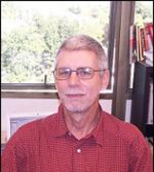 A picture of Professor Larsen, wearing a red button up shirt with short hair