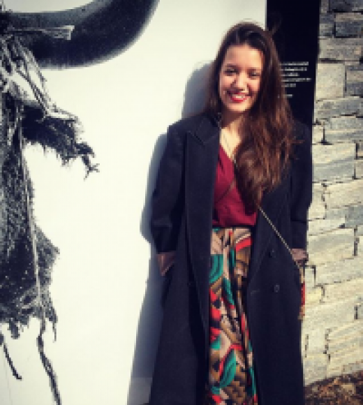 A picture of Jihan Shaarawi, standing and smiling at the viewer