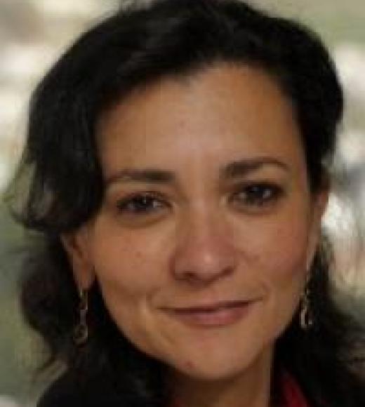 A picture of professor Radwan, smiling and looking at the viewer, wearing a red, collared shirt and black jacket. 