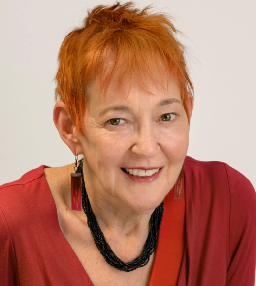 Woman in red blouse and with short red hair