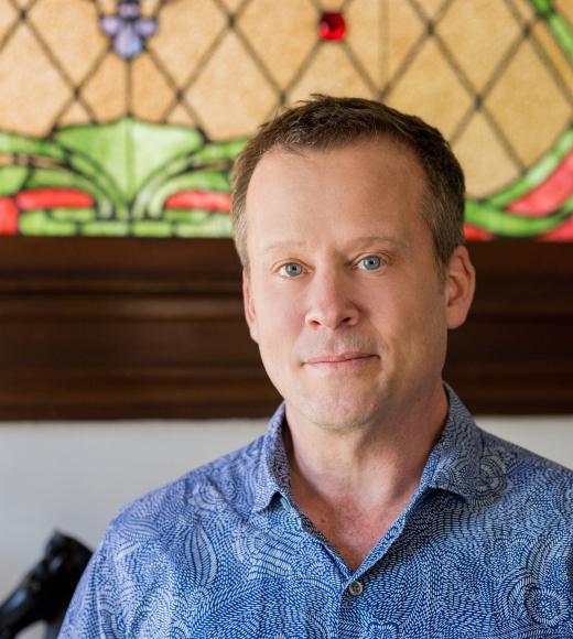 A man wearing a blue shirt with brown hair