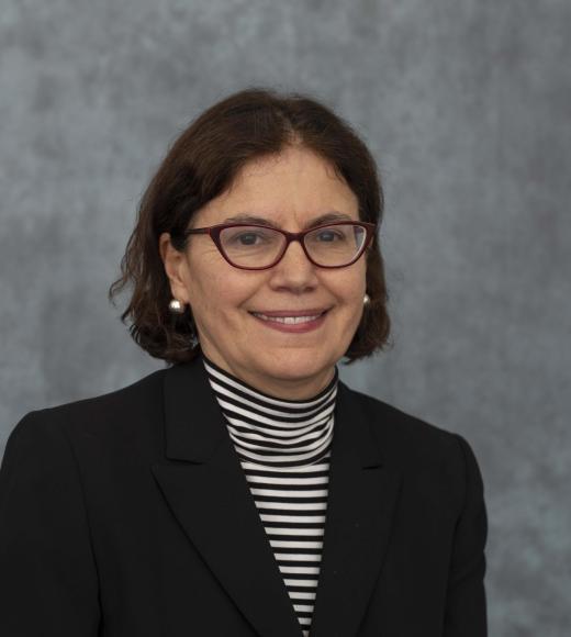 Woman in striped blouse and black suit jacket