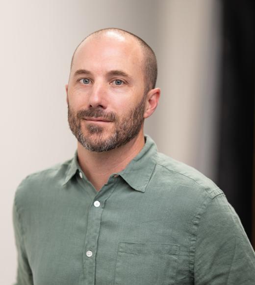 A man in a green button down collared shirt