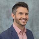 A photo of a man against a gray background.