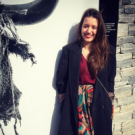 A picture of Jihan Shaarawi, standing and smiling at the viewer