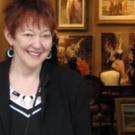 A picture of the Professor, standing in front of pictures 