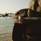 A person in a black shirt standing on the beach