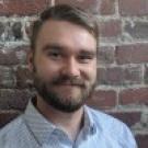 Nick Talbott standing in front of a brick wall