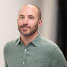 A man in a green button down collared shirt