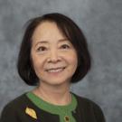 Woman in green blouse and black cardigan