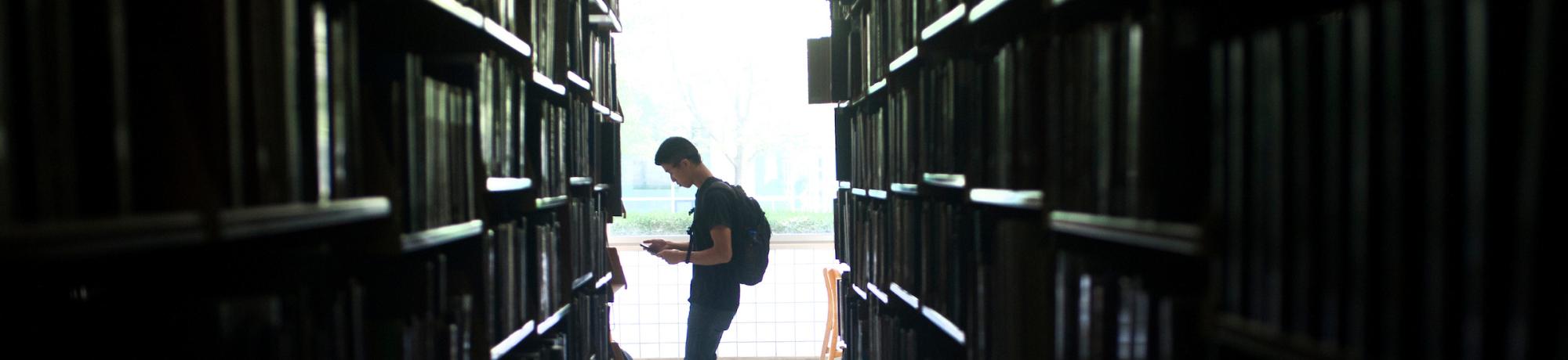 student walking through the library